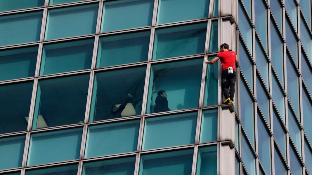 Climber Alex Honnold's rope-free ascent of the Taipei 101 Skyscraper in Taipei, Taiwan, on Sunday. (Ann Wang/Reuters)