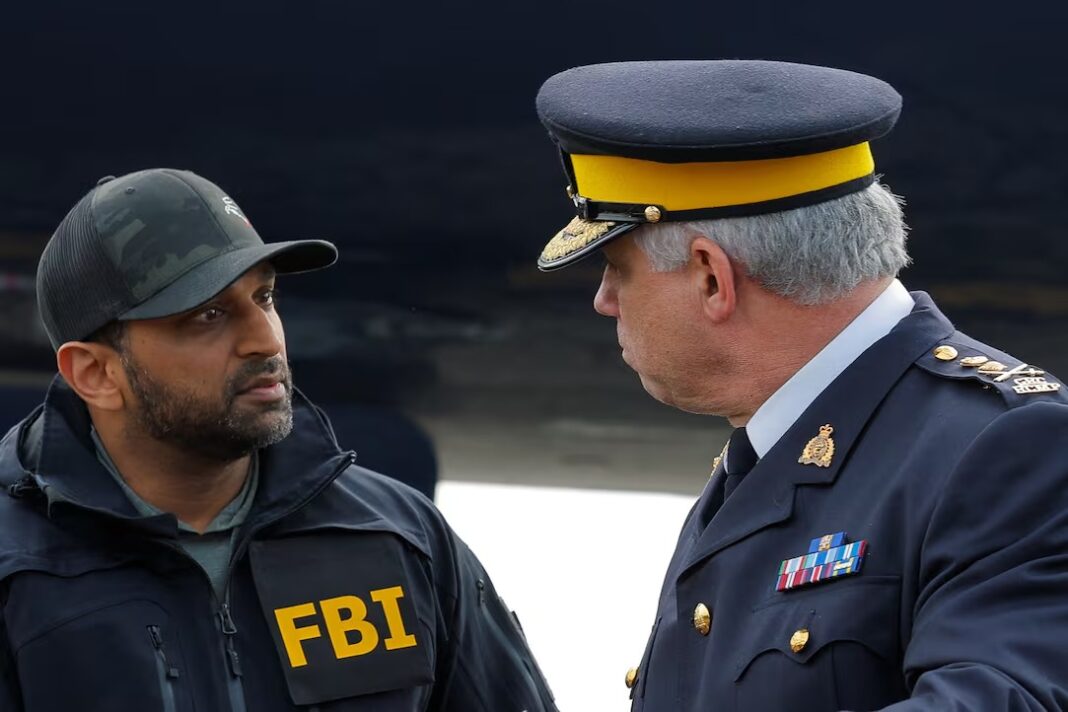 FBI director Kash Patel, left, speaks with RCMP Commissioner Michael Duheme at a Friday news conference in Ontario, Calif., announcing Wedding's apprehension. (Mike Blake/Reuters)