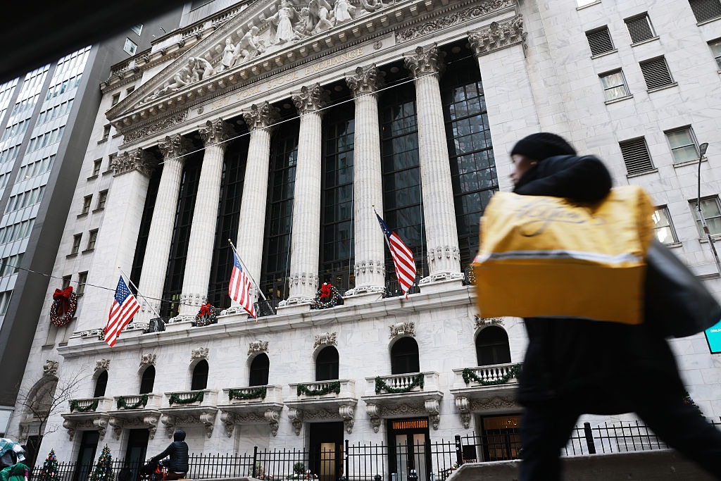 A person walks by the New York Stock Exchange.
